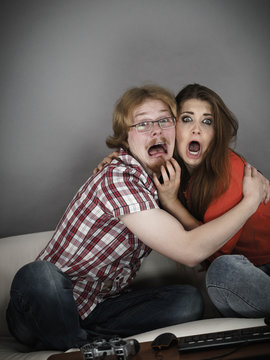 Funny couple watching horror movie
