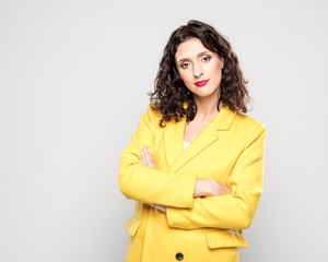 Portrait of confident young woman in yellow jacket