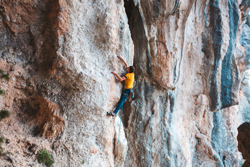 A man climbs the rock.