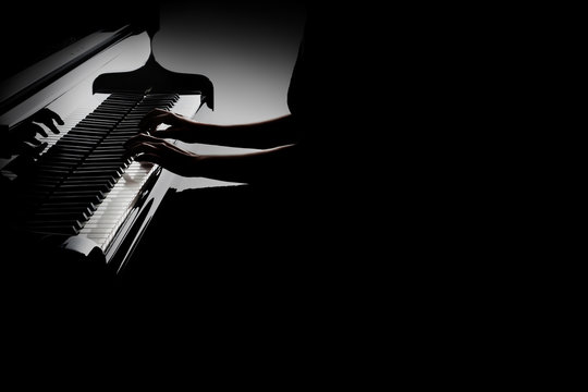 Piano player. Pianist hands playing grand piano