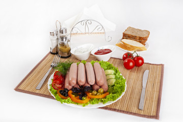 Boiled sausages with tomatoes, cucumbers and greens. Served with black or white bread.