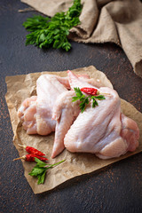 Raw chicken wings on cutting board
