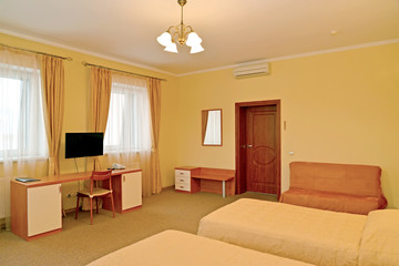 Interior of the hotel room in warm colors. Modern classics