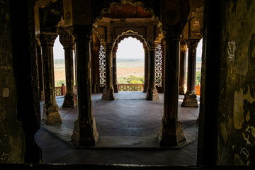 Fototapeta premium View of white marble buildings and palaces through an arch inside Agra Fort fortress UNESCO heritage site in Agra, India. Mughal Islamic architecture in Uttar Pradesh.