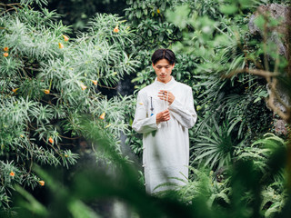 Asian man with zen buddha gesture