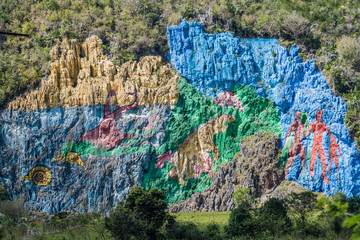 Mural de la Prehistoria (The Mural of Prehistory) painted on a cliff face in the Vinales valley, Cuba. © Matyas Rehak
