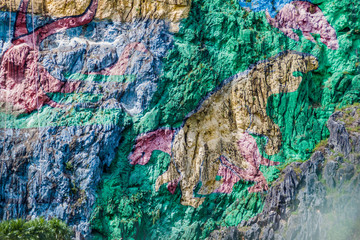 Mural de la Prehistoria (The Mural of Prehistory) painted on a cliff face in the Vinales valley, Cuba. © Matyas Rehak