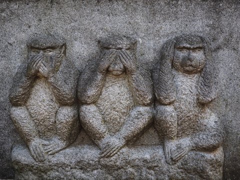 Three wise monkeys who see and hear and speak no evil