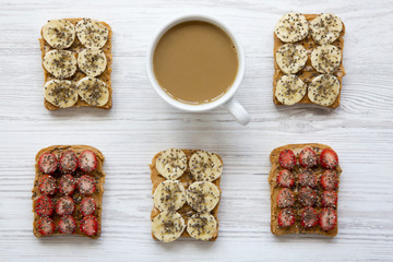 Vegan toasts with cup of coffee on white wooden background, top view. Dieting concept. From above. Flat lay.