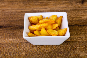 Rustic potato over wooden background
