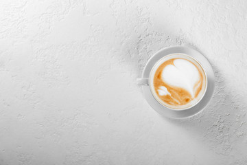 Cup of cappuccino coffee on white background