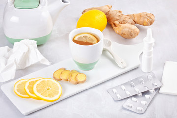 Traditional medicine and alternative methods of flu cure. Pills , nasal spray and hot tea with lemon and ginger to