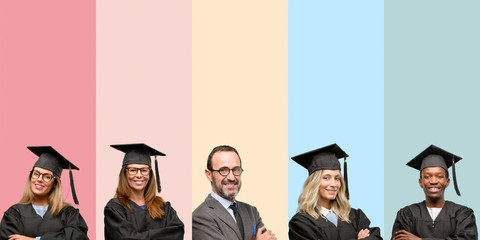 Obraz premium Senior teacher with his graduate students with crossed arms confident and happy with a big natural smile laughing