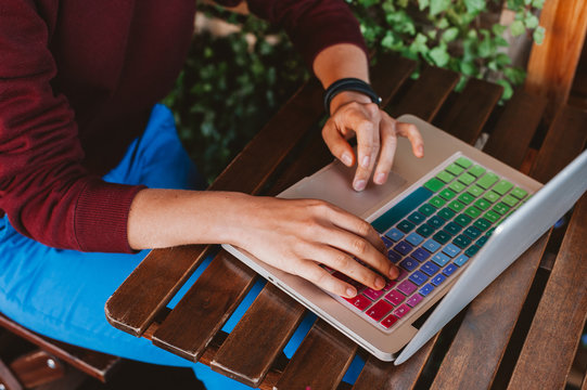 Left-handed woman working on a laptop