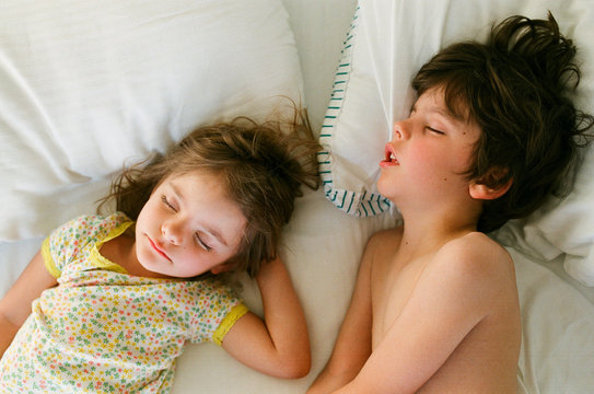 children sleeping in bed