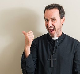 Senior priest religion man pointing with hand and finger up with happy face smiling