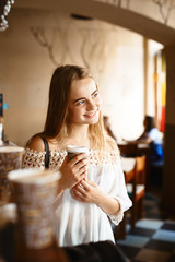 Young smiling woman in cafe