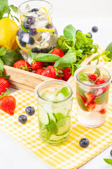 Herbs and fruits flavored infused water. Summer refreshing drink. Health care, fitness, healthy nutrition diet concept.