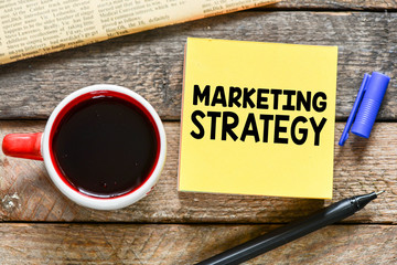 Marketing strategy business text. Concept on sticky note.