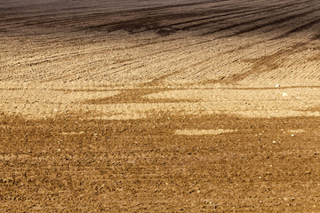 Fototapeta na wymiar plowed soil field