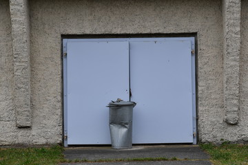 An old gate of a car garage in East-Germany. A small, old village in east-Germany