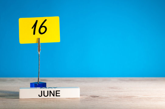 June 16th. Day 16 of june month, calendar on table with blue background. Summer time, empty space for text or template