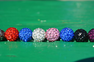 Against the backdrop of a colored green tree, there are colored balls of 8 pieces, beads of...