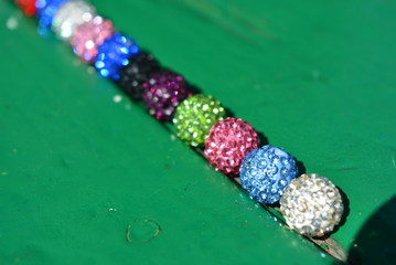 Against the backdrop of a colored green tree, there are colored balls of 11 pieces, beads of...