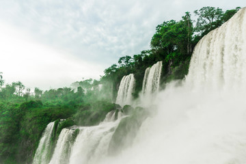 Wide angle landscape view of Iguazu waterfalls on a sunny day in summer. Photo taken from the Argentinian side.