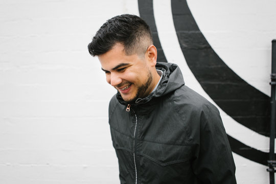 Portrait of Happy young hispanic - latino man standing in front