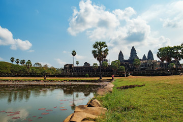 Ancient ruins of temple complex Angkor Wat seen across the pond with lilies, Siem Reap, Cambodia.