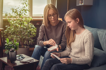 Periods. Menstrual cycle. Mother explains daughter the menstrual cycle and hygiene