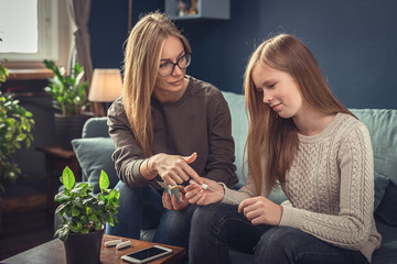 Periods. Menstrual cycle. Mother explains daughter the menstrual cycle and hygiene