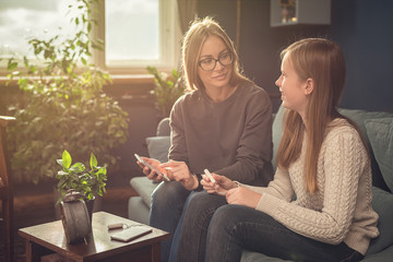 Periods. Menstrual cycle. Mother explains daughter the menstrual cycle and hygiene