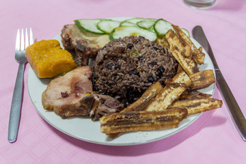 Meal in Cuba - rice with beans (congri], bananas and meat