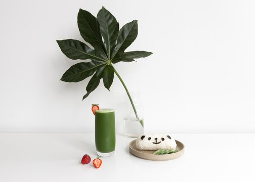 Glass of green tea with panda rice cake