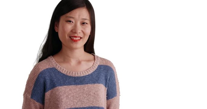 Smiling millennial woman looking joyful and wearing a blue striped sweater on copyspace, Close up of Asian female with happy expression isolated on white background, 4k