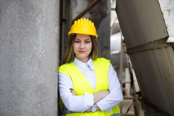 Female worker standing with arms crossed