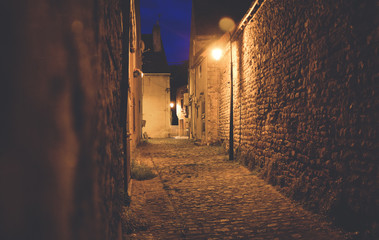Castle street by night lit by lamps