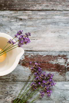 Lavender and a pestle and mortar on a wooden table