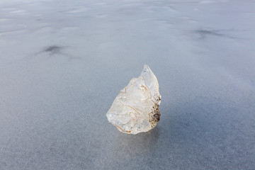Piece of ice on frozen lake surface
