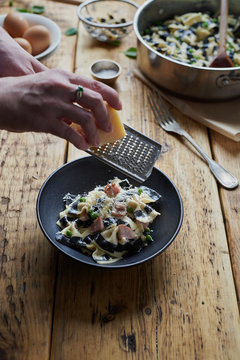 Parmesan Cheese Being Grated Over A Pasta Dish.