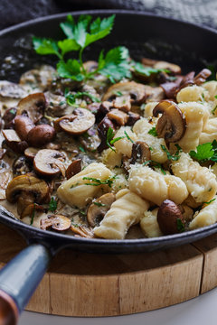 Homemade gnocchi with mushrooms and cream.