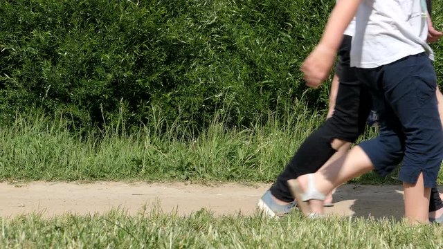 People Walking Feets On Path In Park Low Angle Shot