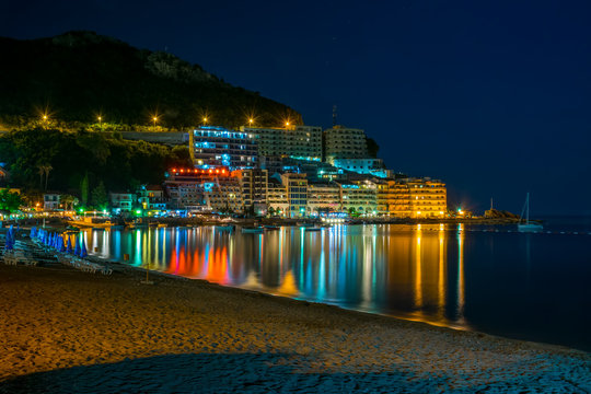 MONTENEGRO, RAFAILOVICI - JUNE 05/2017: tourists walk along the picturesque night embankment on the Adriatic coast.