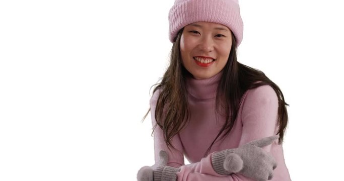 Close up of lovely millennial woman wearing winter outfit and smiling at camera isolated on white background, Lovely young Asian woman posing for camera on copyspace, 4k
