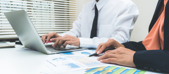 Businessman consult having team meeting discussing new plan financial graph data on office table with laptop and digital tablet, Finance, accounting, investment.
