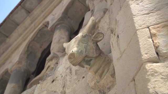 Ancient sculptural head of a bull decorating the wall of the fortress