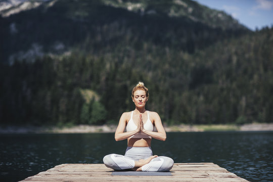 Woman Meditating on Lake