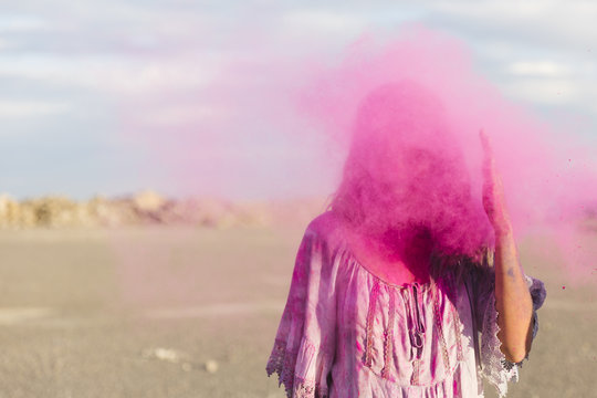 Throwing pink powder on a girl's face